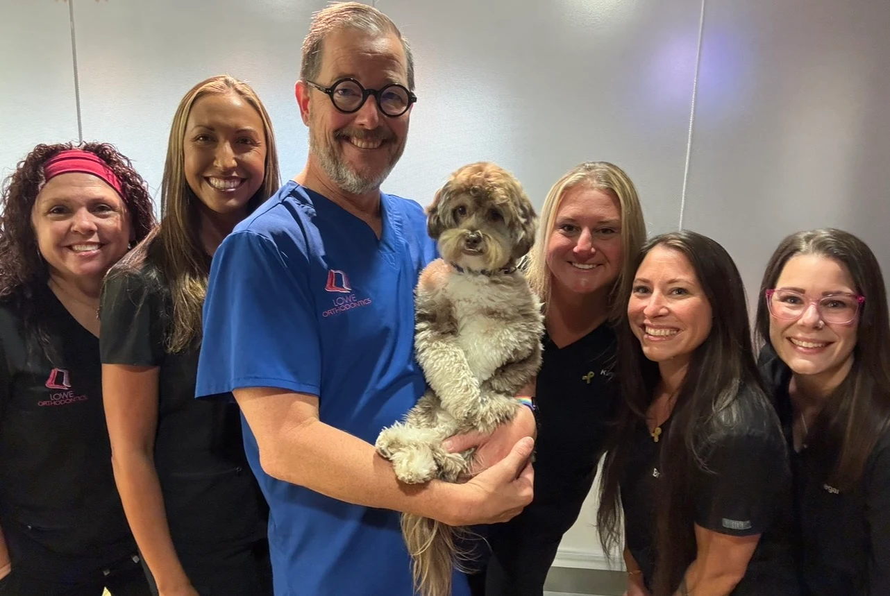 Dr. Lowe and the Lowe Orthodontics team with Toby