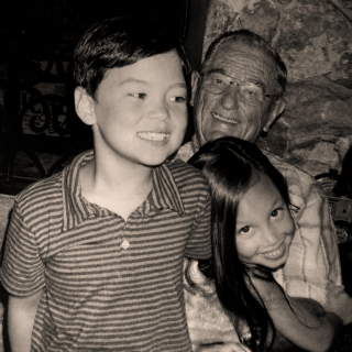 Dr. W.J. Lowe smiling with two children in a family photograph